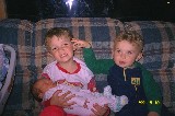 Jacob is holding his new born sister Rachel, while his brother David is assisting Jacob is holding his new born sister Rachel, while his brother David is assisting