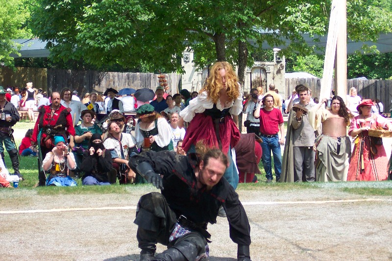 Human Chess. The King and Queen plays chess with Human pieces. The pieces fight before they get off the board