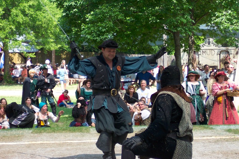 Human Chess. The King and Queen plays chess with Human pieces. The pieces fight before they get off the board