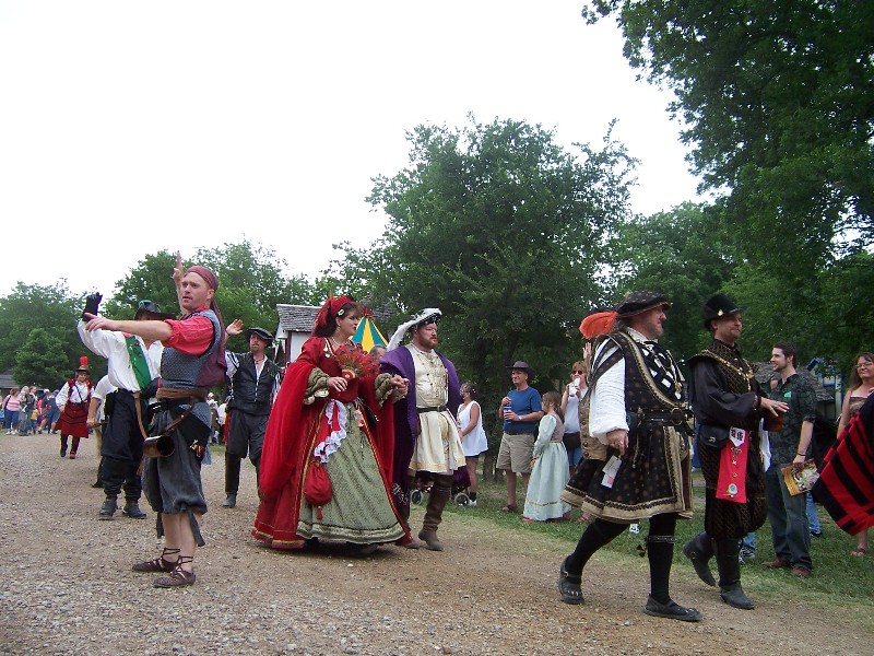 The King is in purple the Queen in Red. Every day they have a parade at Scarborough Faire. There are several hundred participants including the King and the Queen