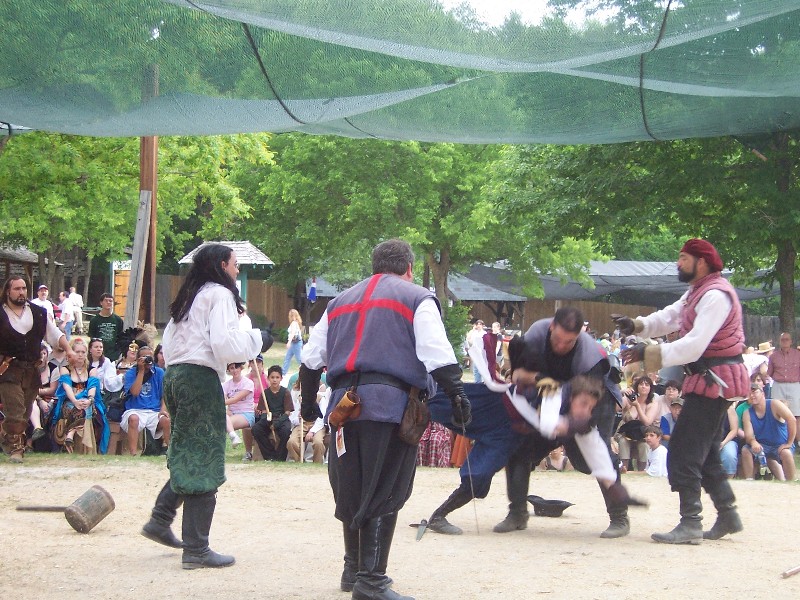 Human Chess. The King and Queen plays chess with Human pieces. The pieces fight before they get off the board