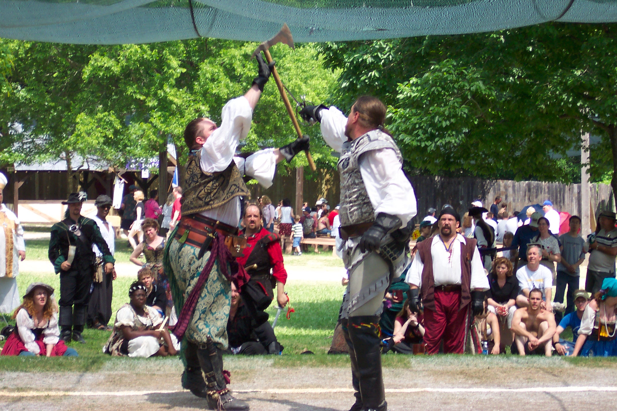 Human Chess. The King and Queen plays chess with Human pieces. The pieces fight before they get off the board