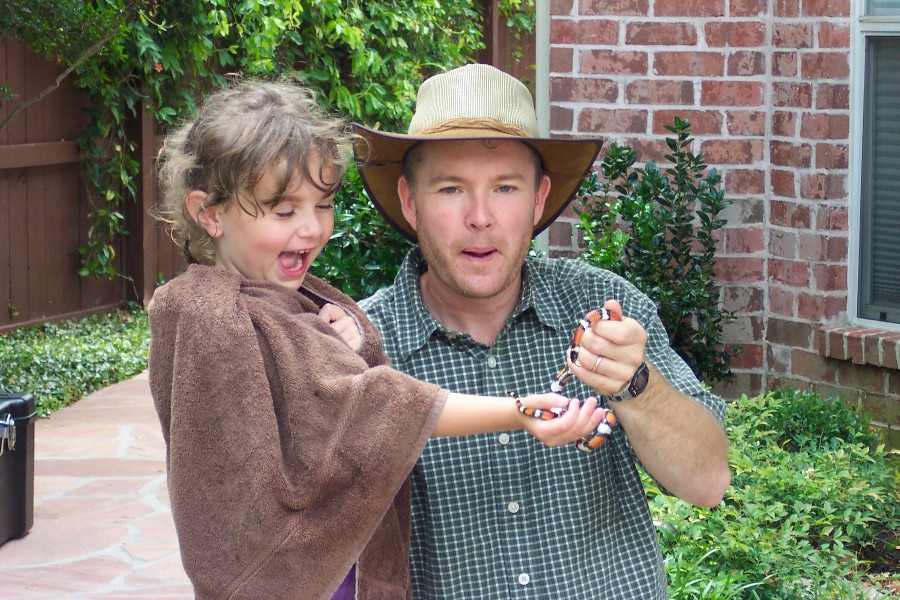 Critter man with a milk snake. Critter man came for my fifth birtday. He was showing Texas critters. The milk snake is harmless, but it looks like the Texas Coral Snake which can kill ten adults. To know the difference. Red touches Yellow you are a dead fellow, Red touches black you are Okey Jack.