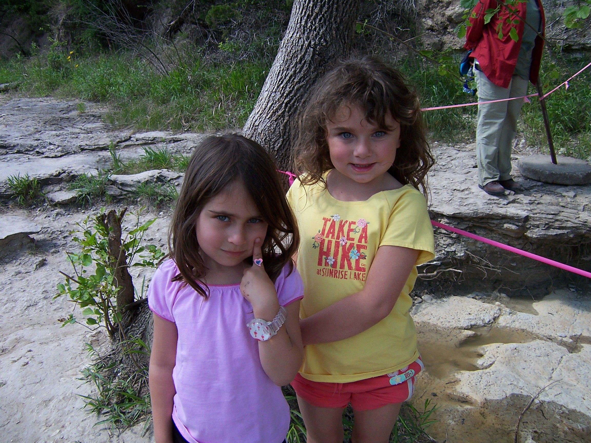 Rachel and Enav, at Dinosaur Valley State Park. Dinosaur footprints in the background. 