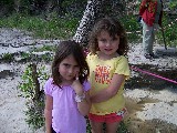 Rachel and Enav, at Dinosaur Valley State Park. Dinosaur footprints in the background.